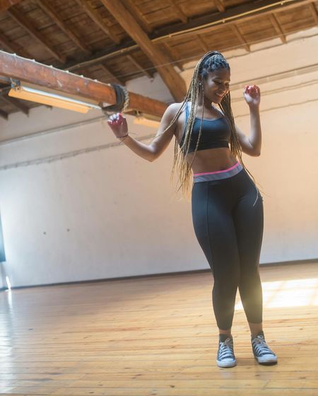 Woman feeling energetic and balanced in a bright, modern space.